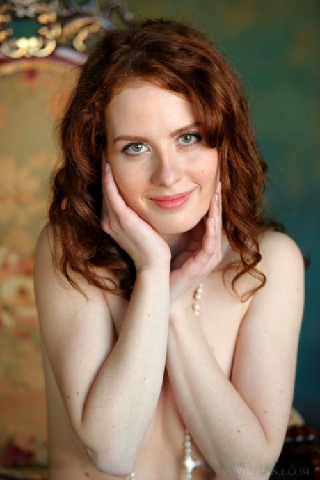 Elegant redhead poses in pearls and white stockings to flaunt her hairy muff