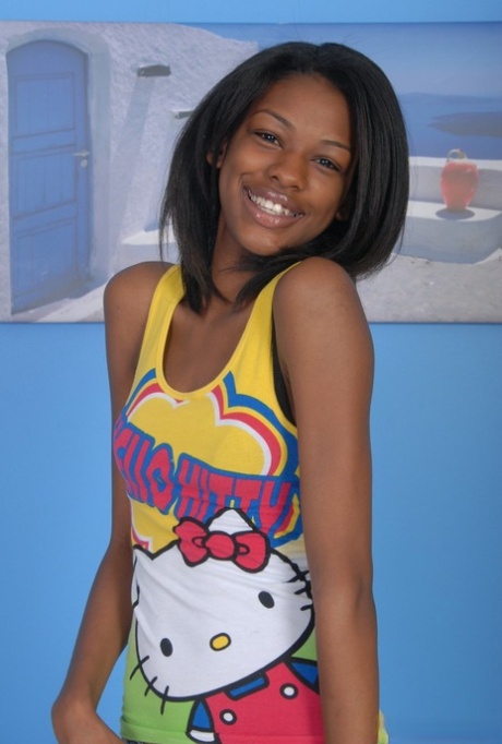 Petite ebony girl parts her hairy pussy after taking off her clothes