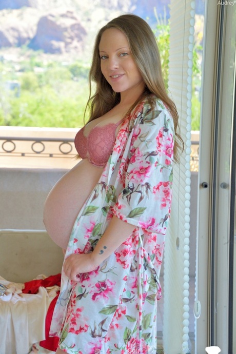 Pregnant girl Audrey toys her pussy after displaying her swollen belly