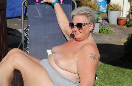 Fat nan Valgasmic Exposed licks a shoe while exposing herself in the backyard