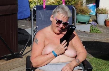 Fat nan Valgasmic Exposed licks a shoe while exposing herself in the backyard