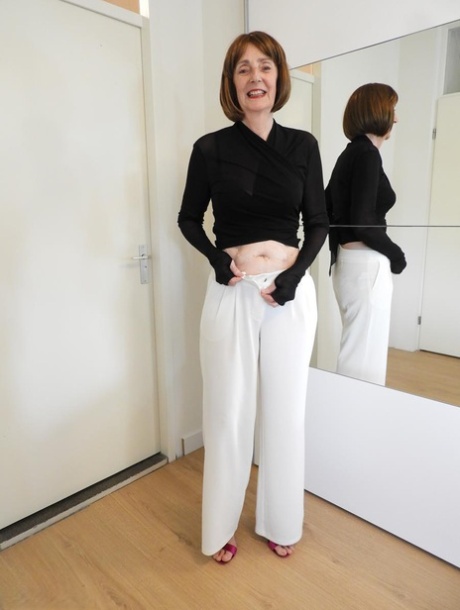 Caucasian grandmother Kat Kitty strips to her heels afore a mirror