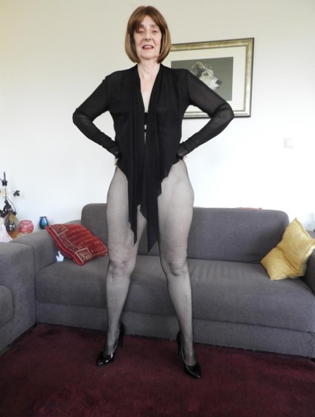 Redheaded granny Kat Kitty gets bare naked before inserting a sex toy