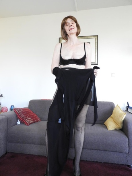Redheaded granny Kat Kitty gets bare naked before inserting a sex toy