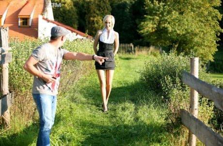Blonde female captures a stream of pee in her mouth after outdoors sex