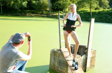 Blonde female captures a stream of pee in her mouth after outdoors sex