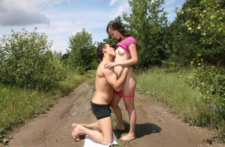 Brunette teen and her boyfriend fuck in the middle of a dirt road in the woods