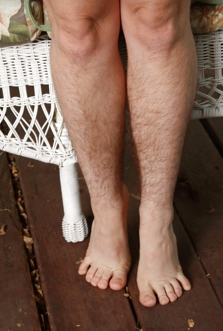 Lascivious hairy mature slut getting rid of her clothes outdoor