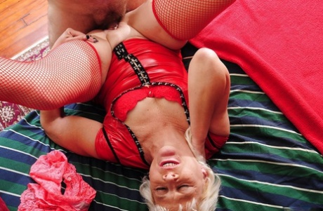 Blonde granny Sindy seduces a younger guy while in her red stockings