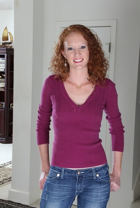 Skinny curly-haired mature woman Ande is posing on the stairs