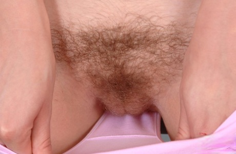 Natural redhead Denisa plunges her hairy vagina into a bathtub full of water
