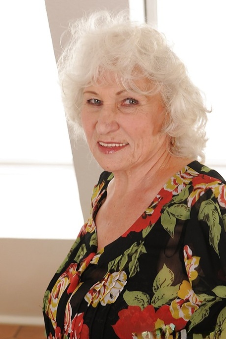 Salacious granny in stockings undressing and exposing her shaggy twat