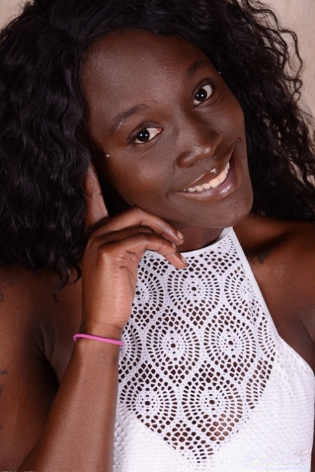 Busty black babe London Blaq spreads her shaved pussy after a sexy striptease