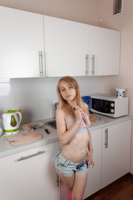 Little seductress Lightfairy strips in the kitchen & shows her furry muff
