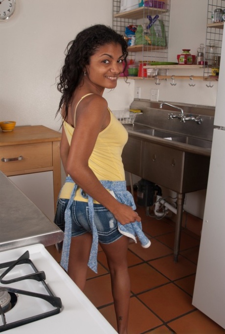 Ebony sweetheart Neela Sky gets naked & shows her hairy cunny in the kitchen