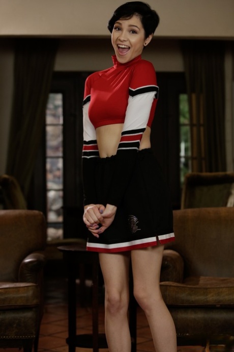 Cute cheerleader Cadey Mercury hikes top & skirt up to show perky tits & twat