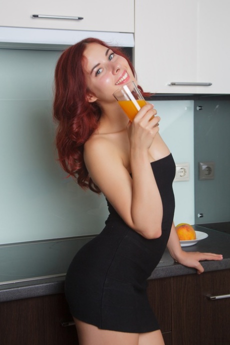 Redheaded Belarusian babe Pearl Ami strips her dress & poses naked