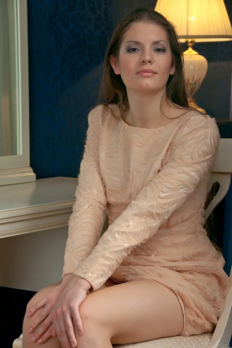 Beautiful brunette Sabina B undresses and poses naked in the chair