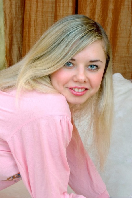 Pretty blonde teen Klara A strips naked and shows off her lovely tits