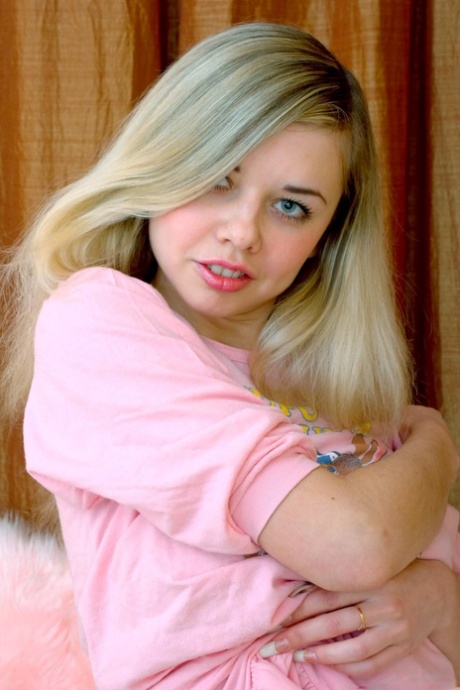 Pretty blonde teen Klara A strips naked and shows off her lovely tits