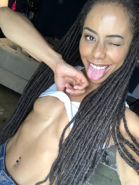 Beautiful ebony teen Kira Noir reveals her hot ass and tiny tits in a solo