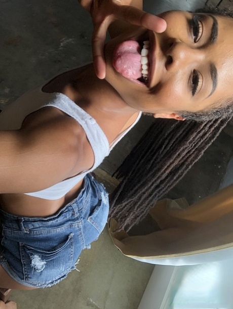 Beautiful ebony teen Kira Noir reveals her hot ass and tiny tits in a solo