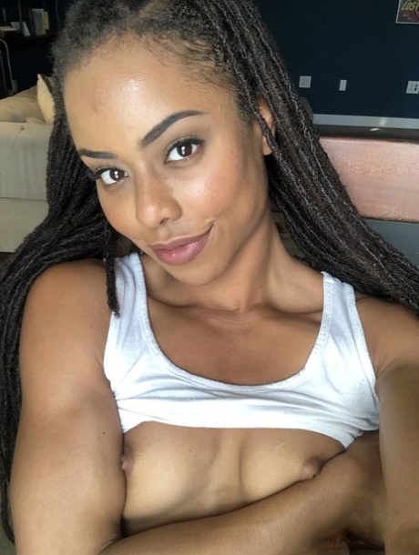 Beautiful ebony teen Kira Noir reveals her hot ass and tiny tits in a solo