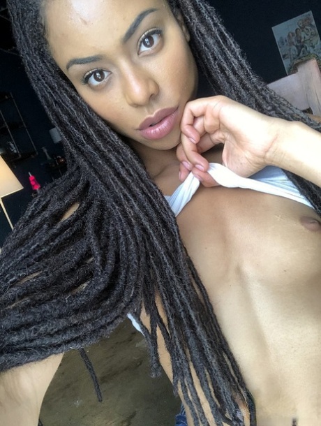 Beautiful ebony teen Kira Noir reveals her hot ass and tiny tits in a solo