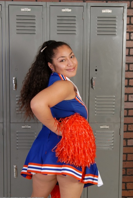 Petite curly haired cheerleader Reena shows her fat ass and hairy pussy