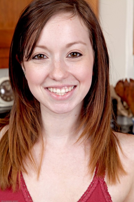 Cute ginger Ally Evans unveils her big tits and rubs her beaver in the kitchen