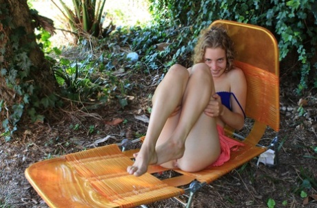 Adorable babe Kara Dasha shows her juicy tits and her hairy pussy outdoors