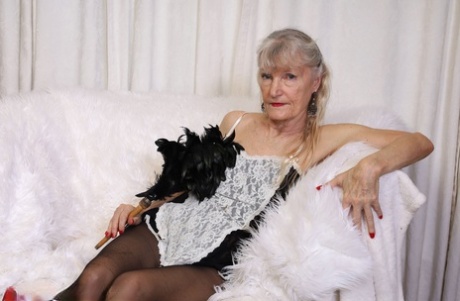 Horny old granny in a maid outfit Linda Jones strips her clothes & masturbates