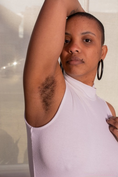 Curvy short-haired amateur Erykah Ohms spreads her very hairy pussy up close
