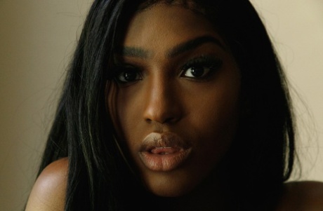 Naked ebony babe Kelsey Jones shows her tight ass and her small tits