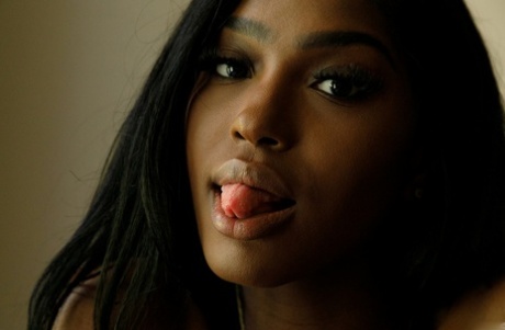 Naked ebony babe Kelsey Jones shows her tight ass and her small tits