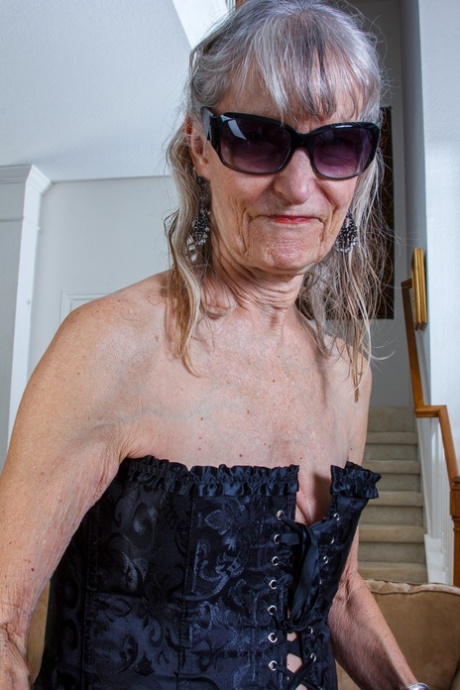 Gorgeous granny Candis strips naked and pounds her pussy with a toy