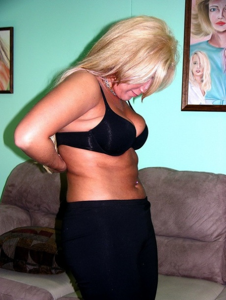 Mature blonde Monique shows her shaved pussy while completely naked