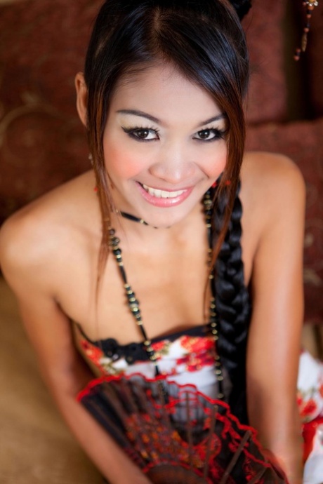 Thai beauty Tong strips her lace panties and shows her trimmed snatch