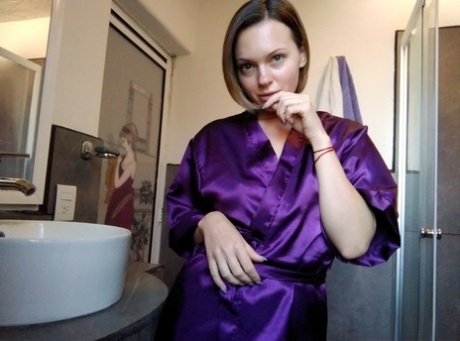 Naughty brunette amateur displaying her big tits and booty in the bathroom