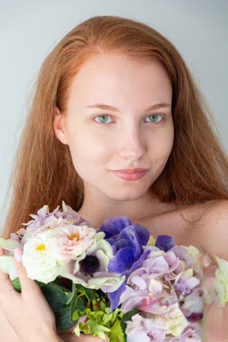 Blue-eyed redheaded babe Lola Jolie strips down naked and poses
