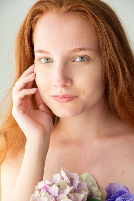 Blue-eyed redheaded babe Lola Jolie strips down naked and poses