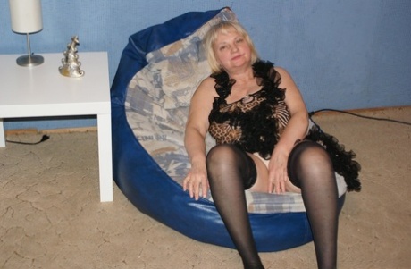 Chubby old granny Helga exposes her big tits and poses in lacy stockings