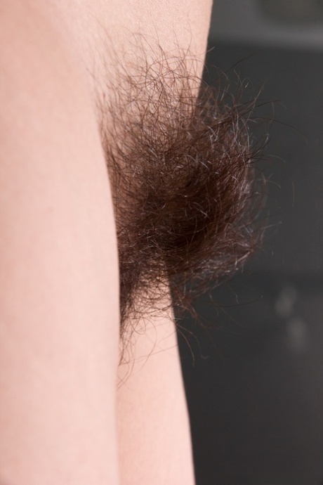 Skinny teen Baby Lizza reveals her hairy armpits and crotch in solo action
