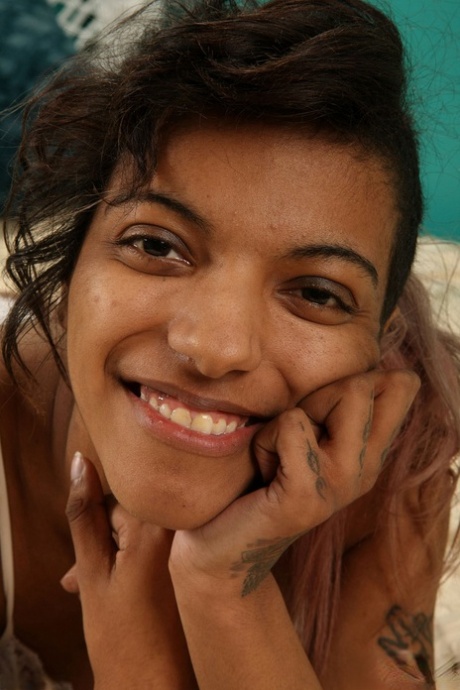 Afro-American cutie Yvette displays her inked feet and chocolate holes